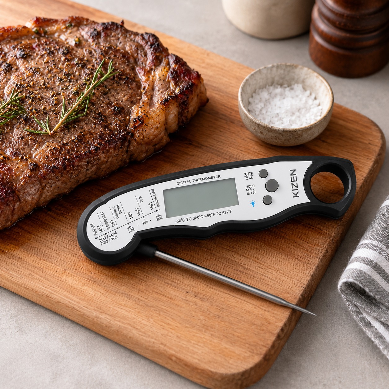 KIZEN digital meat thermometer beside cooked steak