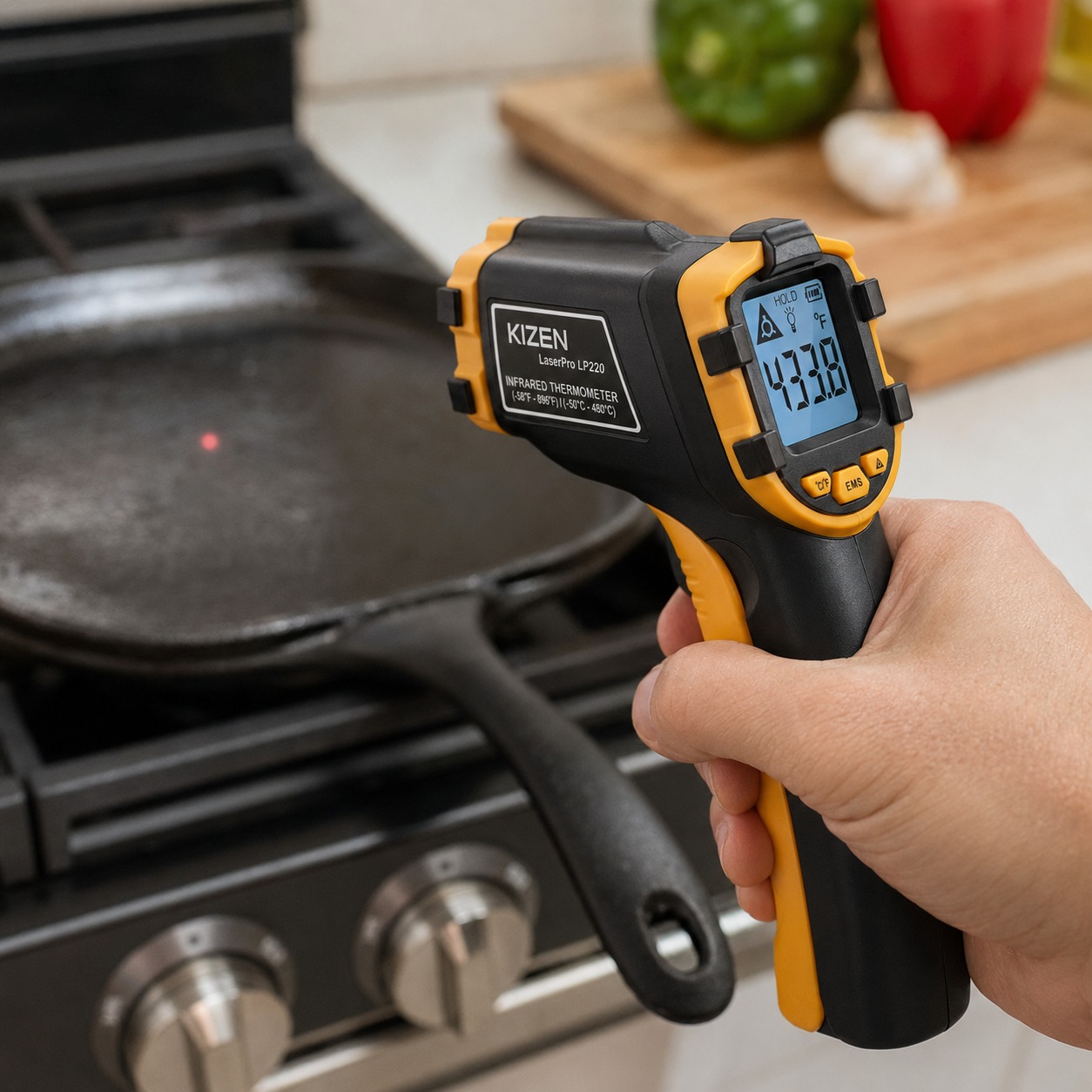 KIZEN infrared thermometer gun aimed at a pan